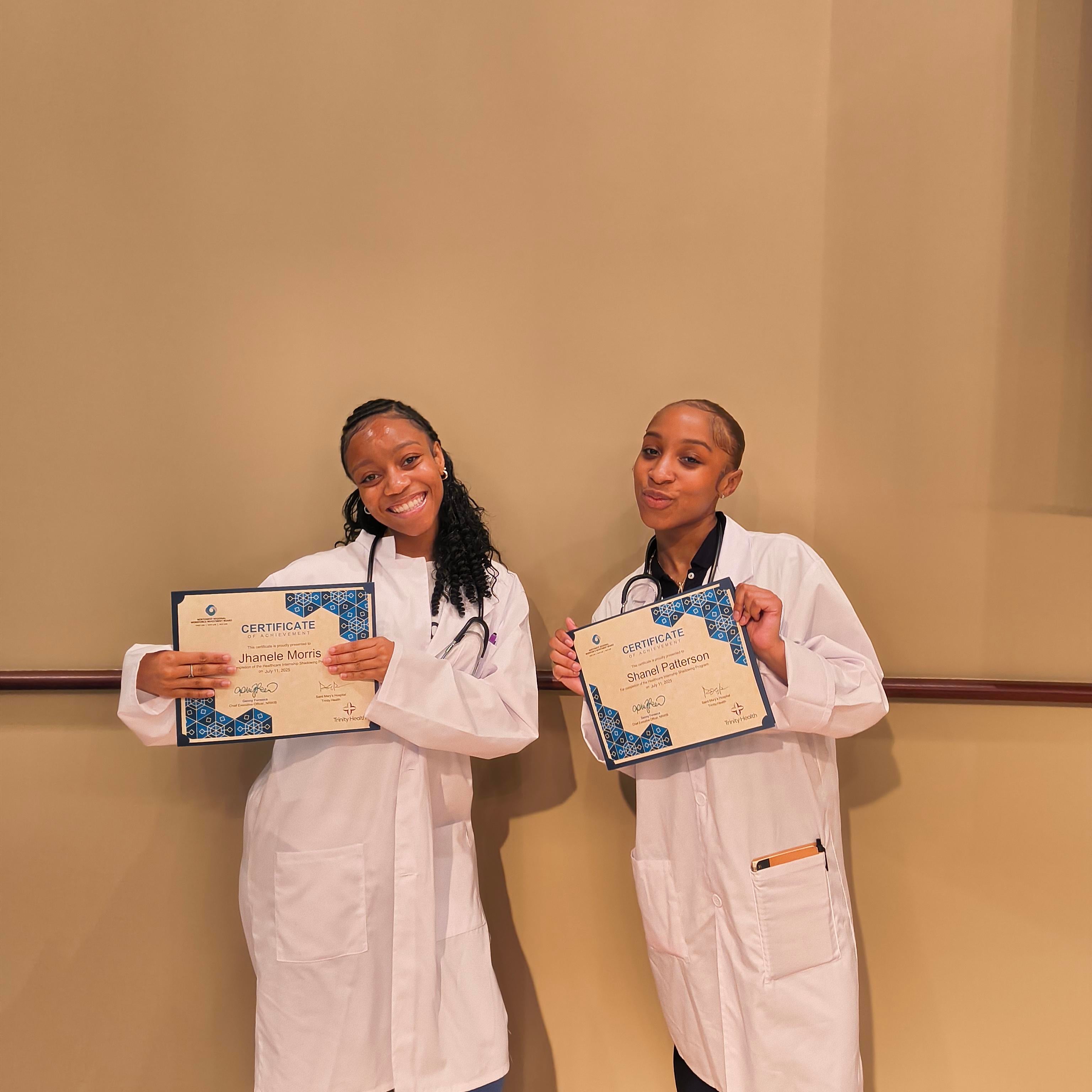 Summer Shadowing Program graduates smile with certificates.